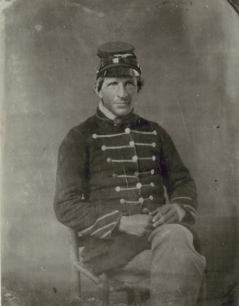 Three-quarter length seated portrait of an unidentified Civil War soldier.