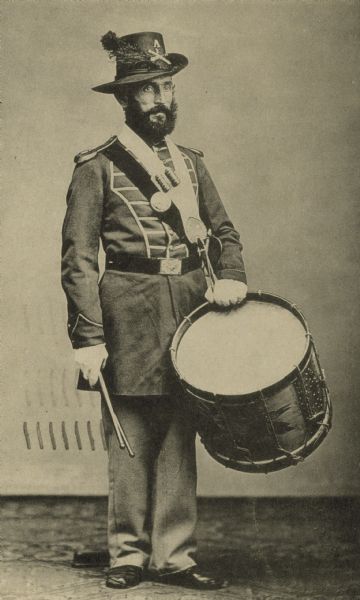 Full-length standing portrait of an Union army musician of an artillery battery.