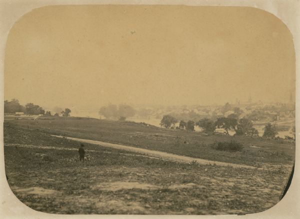 The 7th Wisconsin Volunteer Infantry Regiment camp outside of Fredericksburg on the east side of the Rappahannock.  Fredericksburg and a pontoon bridge leading to it over the Rappahannock can be seen in the background.