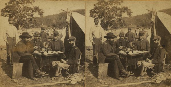 Stereograph of Union officers eating a meal in camp.