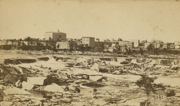 Falls of Saint Anthony with Saint Paul on the opposite shoreline in the background.