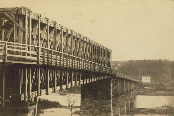 A carte-de-visite of an 1790 foot long bridge, 90 feet above the Mississippi River, with the main span at a length of 240 feet in length, at Saint Paul Minnesota.