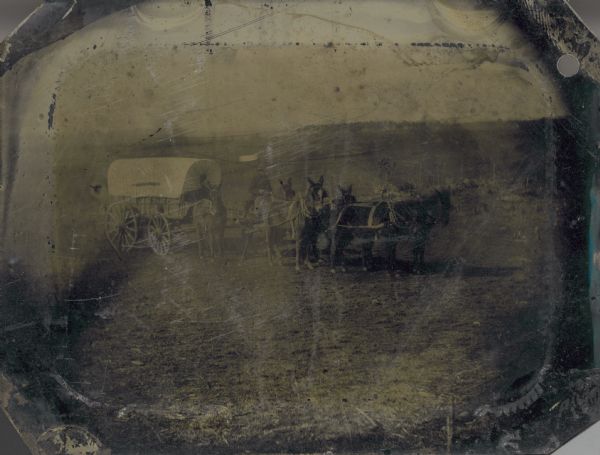 Tintype (ferrotype) of a covered wagon on the plains.