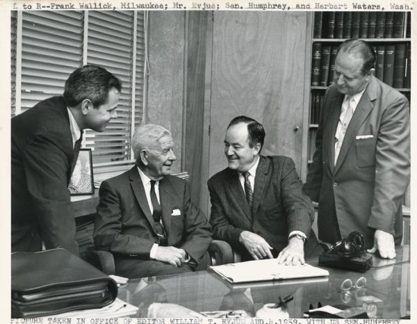Four men in the office of editor William T. Evjue.  The people from left to right are Mr. Frank Wallick (of Milwaukee), Mr. William T. Evjue, Senator Humphrey, and Mr. Herbert Waters (of Washington).