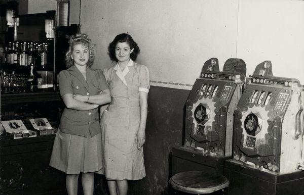Two women pose next to gambling machines at Buddy's Place, in the township of Rib Mountain. The bar operated as a house of prostitution.