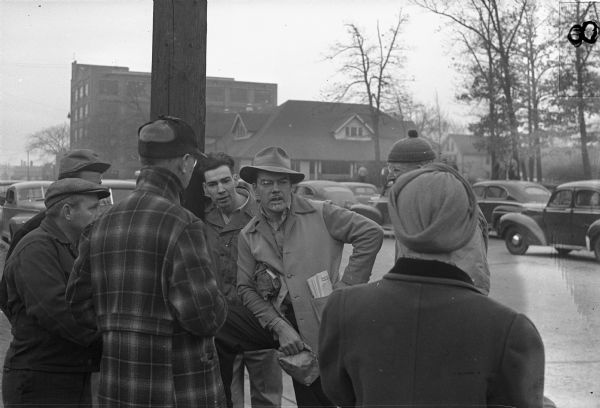 Striking members of Local 248, United Automobile Workers, discuss strategy outside the Allis-Chalmers Manufacturing Company plant.