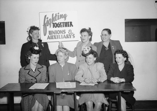 The International Executive Board of the United Automobile Workers Auxiliaries demonstrating its support for the Allis-Chalmers strike. 

"CIO photographer asked them to pose for this picture at Local 248's clubhouse."  - Wisconsin CIO News.

Left to right, seated: Maxine Lewis, Flint; Dorothy Keene, international president, Rockford; Catherine Gelles, international secretary-treasurer, Detroit; Mable Mayne, Ontario.  Standing: Mildred Falls, Evansville; Florence Kasper, Detroit; Joye Newton, Rockford.
