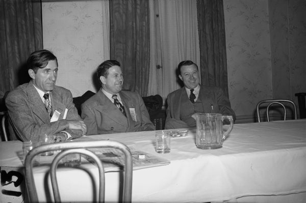 Walter Reuther, President of the United Automobile Workers (right), after delivering address to the Wisconsin State CIO convention, December 6, 1947. To his immediate right is Pat Greathouse. Man on left is unidentified.