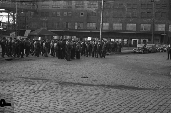 Packinghouse workers and their CIO supporters protest Armour and Company's "back-to-work" day, April 20, 1948.<p>"The 'back to work' movement of Armour & Co., an effort to break the seven week old strike of the United Packinghouse Workers, failed to get any union members to return to their jobs.  Union officials pointed out that fewer non-union workers crossed the lines than any day since the strike.  Members of Local 50 [Plankinton Packing Company] and 32 [Armour and Company], who are demanding a 29 cent an hour wage increase, drew picket-line reinforcements from all CIO locals in Milwaukee Monday morning."<p>Wisconsin CIO News</p>