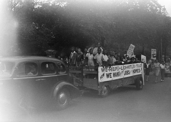 The 6th Ward Contingent represented a community on the march. Black men, women and children from the CIO and AF of L, from small business, brought a message to the community that attacked Bilboism, the polltax, and called for jobs for all. Children carried signs saying, "Our Daddies Helped Lick Hitler and Tojo, Give Us A Square Deal." - Wisconsin CIO News