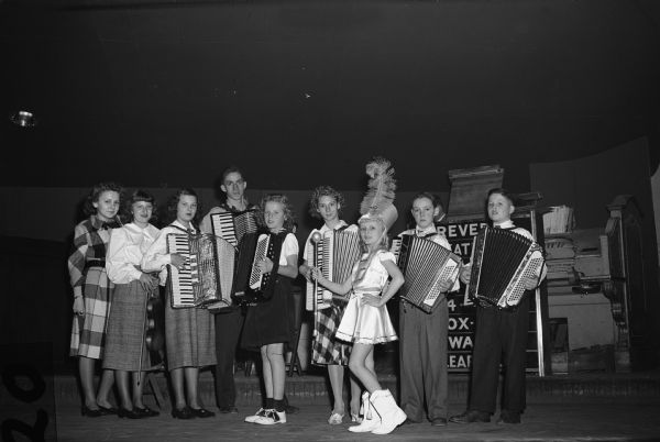 Children of members of Local 75, United Automobile Workers (Seaman Body Company) performing at the union Christmas party. There are accordion players and a majorette.<p>"More than 4,000 persons were present to enjoy the entertainment of the above group, which performed at the UAW-CIO, Local 75 Christmas party Saturday morning, Dec. 13, at the Riverview Ballroom.  The entertainers were children of Local 75 members."<br>- Wisconsin CIO News<p>Left to right: Lois Pierner, Jackie Zeromski, Beverly Zeromski, Herman Handlos, Marylyn Klisch, Gail Takala, Margaret George, James Riordan, and Gerald Boldt.</p>