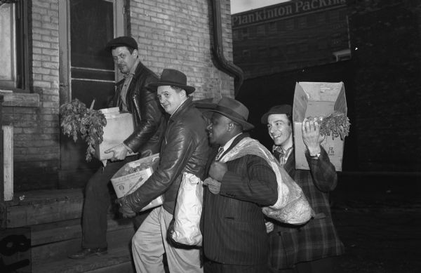 Workers stocking the strike kitchen of Local 50, United Packinghouse Workers of America (Plankinton Packing Company).  Left to right: Fred Koratko, Cornelius Bialk, George Barber, and Harry Stikarski.<p>"There's no lack of supplies to keep the soup kitchen going at Local 50 headquarters.  That's the supply committee pictured above with part of a day's collection from willing local merchants, who have been contributing to the strikers."<br>- Wisconsin CIO News</p>