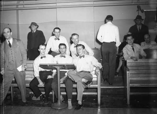 Already assured of the UAW Local 75 Bowling league title is the Cushions line-up shown here. The sockers have lost only four games in 54 to date in the strike thumping done on the Antler's Alleys drives. The club is hitting an 832 pace. - Wisconsin CIO News Left to right, standing: Art Schuenke, averaging 178; and Ray Behrens (captain), 170. Seated: Bill Doll, 149; Mike Nowak, 163; and Ed Wojciechowski, 172.