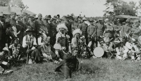 Chippewa (Ojibwa) Indians and returned soldiers posing at the Victory celebration. Ira O. Isham, Chippewa interpreter, is in the foreground.