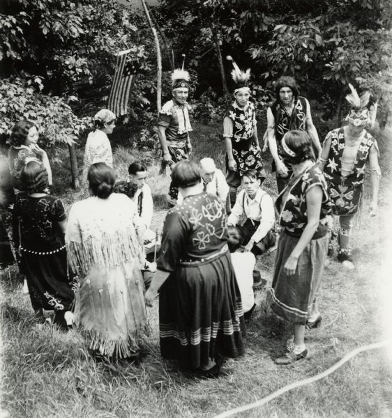 Slightly elevated view of a Menominee Ceremony, possibly the beginning of a dance.