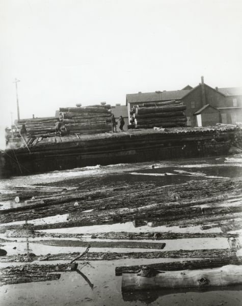 Indians (Native Americans) unloading logs at the sawmill on the Menominee Reservation.