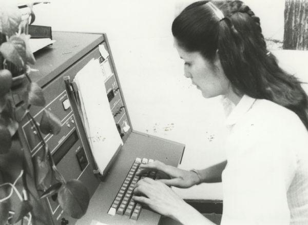 Pamela J. Waukau, typesetting the "Menominee Tribal News".