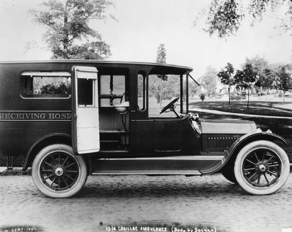 A 1914 Cadillac Ambulance in a park. It's body was produced by the W.S. Seaman Company.