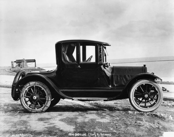 A 1914 Cadillac sitting near Lake Michigan.  Its body was produced by the W.S. Seaman Company.