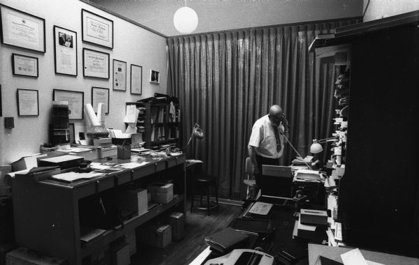 Ansel Adams talks on the telephone in his home office.
