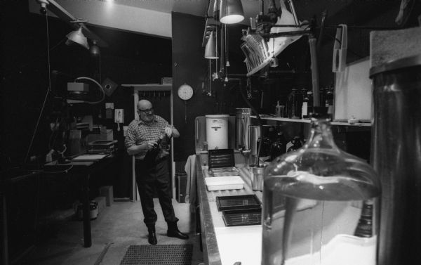 Ansel Adams at work in his home darkroom.