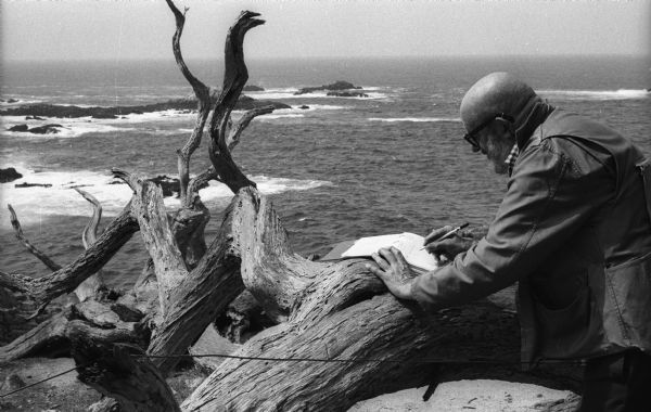 Ansel Adams takes exposure notes during a photo shoot at Point Lobos.