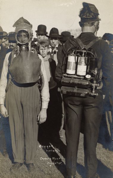 Two men in oxygen helmets outside of the Cherry, Illinois, mining disaster.