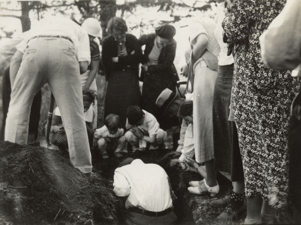 Members of the Wisconsin Outing Club watch the excavation of a burial mound at the Outlet group in 1935.