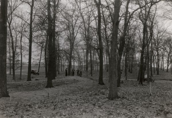 A field party lead by Charles E. Brown prepare to excavate the Heim effigy mound. The effigy, shaped like a fox or wolf, has been outlined by stakes. The mound still stands in what is now a residential neighborhood in Middleton, Wisconsin.