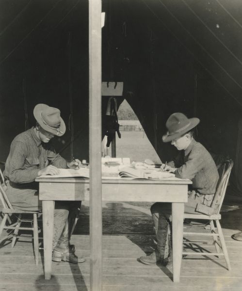Philip La Follette (right), doing paperwork while in the Army during the First World War, 1918. He was a Second Lieutenant infantry instructor in Oklahoma.