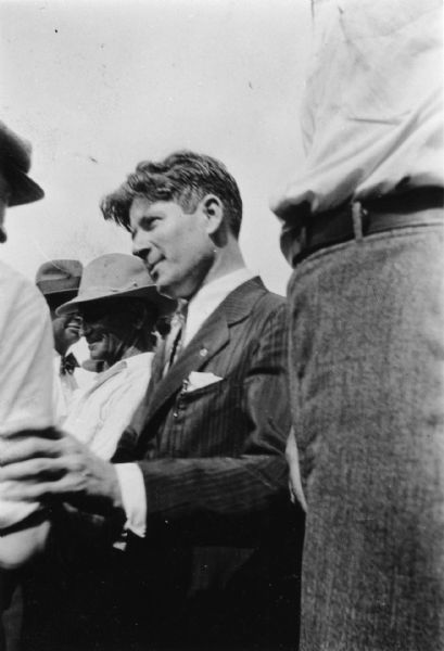 Mastering the handshake is essential for a successful political candidate. It involves not only the right hand in the shake, but also the left, used in a gesture that reflects attentive listening on the part of the candidate. Here during the 1930 campaign, Philip Fox La Follette, gubernatorial candidate and son of Robert M. La Follette, Sr., demonstrates his mastery.
