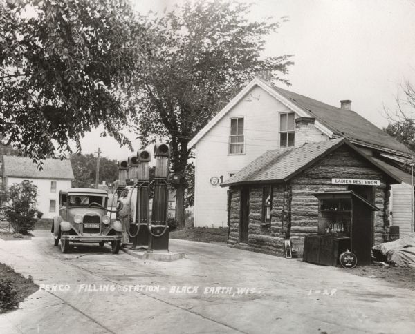 The Penco Filling Station in Black Earth. Wisconsin.  Entrances to the ladies rest rooms in the service stations of this period were typically outside the station, while the men's room was inside.  The condition of rest rooms was always a concern for early women motorists.  Note that the gasoline tank was filled from the top.