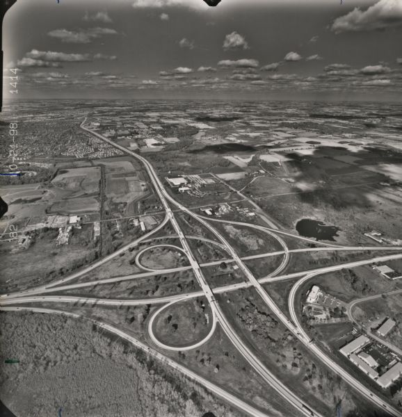 North-facing aerial view of the interchange between Interstates 39/90 and US Routes 12/18 in the southeast of Madison. Femrite Drive can be seen passing beneath the Interstate just to the north of the interchange.