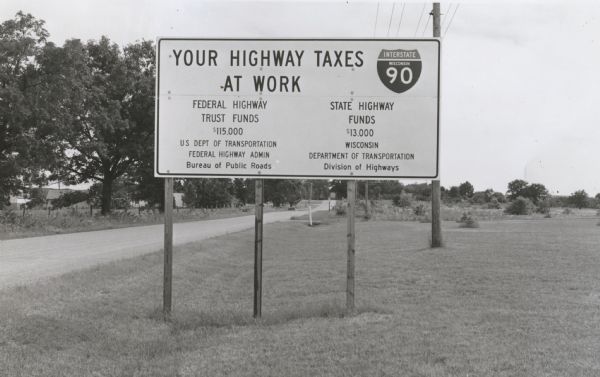 Interstate Highway I-90 sign erected to point out to motorists the use of tax dollars in highway improvements.