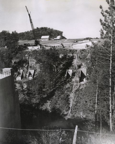 Elevated view of the interstate highway bridge construction at Mirror Lake showing the concrete footings halfway down the embankment.