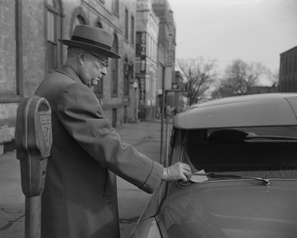 Although probably a posed shot, Madison photographer John Newhouse has nevertheless managed to capture much of the annoyance associated with receiving a ticket for an expired parking meter.