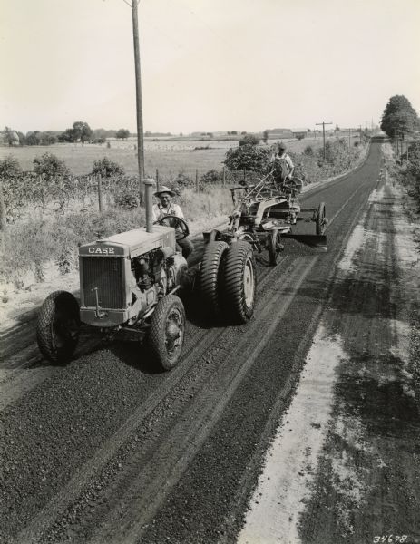 This image which was probably taken for publicity purposes by the company, shows a J.I. Case Model L tractor pulling a Galion E-Z Lift road grader.