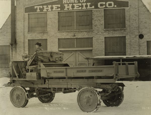 Highway Commission dump truck photographed outside the Heil Company factory in Milwaukee.  The truck was a Nash four-wheel drive model with the body built by the Heil Company.
