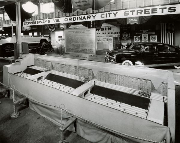 Exhibit in the Transportation Building at the Wisconsin Centennial Exposition, which included this model from the U.S. Public Roads Association. The model demonstrated the ability of limited access expressways to carry more traffic at a higher rate than ordinary city streets.