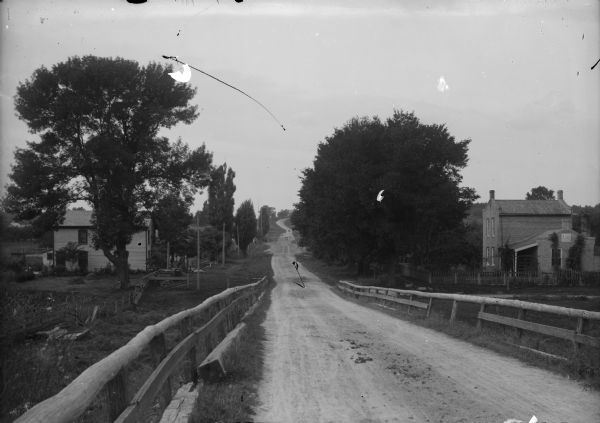 View of an unidentified road, probably near Manitowoc, illustrating typical road conditions of the era.