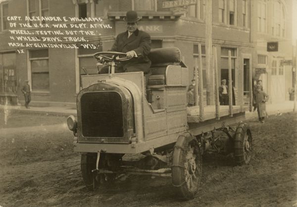 Captain Alexander E. Williams of the War Department testing the experimental truck that the Four Wheel Drive Company hoped to manufacture for the army. In addition to the four-wheel drive, the vehicle is equipped with chains to negotiate Clintonville's muddy streets. Ultimately the company manufactured over 20,000 trucks for the American and British armies.
