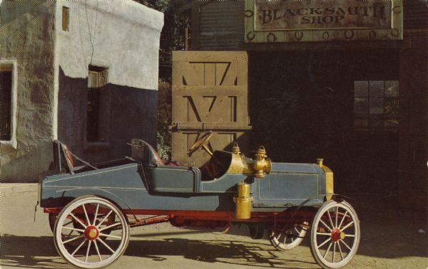 A restored early Mitchell originally manufactured in Racine. The color postcard was an advertisement of the Moore Oil Company of Milwaukee. The Mitchell Company, later the Mitchell-Lewis Company, manufactured automobiles from 1906 until 1920.