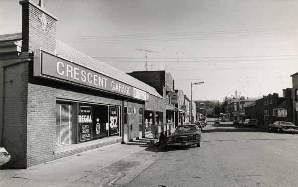The Crescent Garage. Although the photograph dates from 1981, the curb-side gas pumps are a throwback to the early days of gas stations. The Crescent Garage was not only a service station, but it was also an exclusive Buick dealer, selling from 100 to 150 news cars a year in the city.