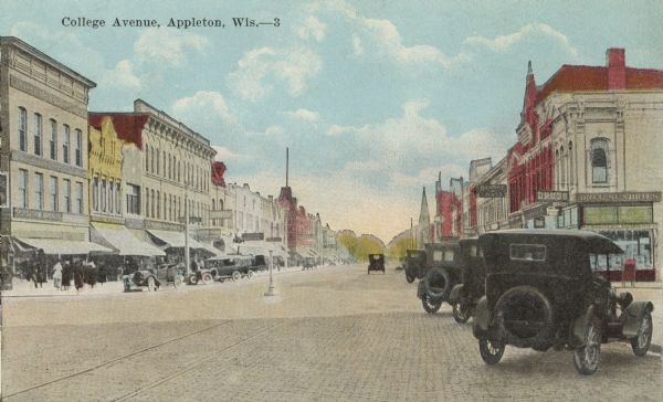 Colorized view of automobiles parked on College Avenue, the brick-paved main street. Caption reads: "College Avenue, Appleton, Wis."