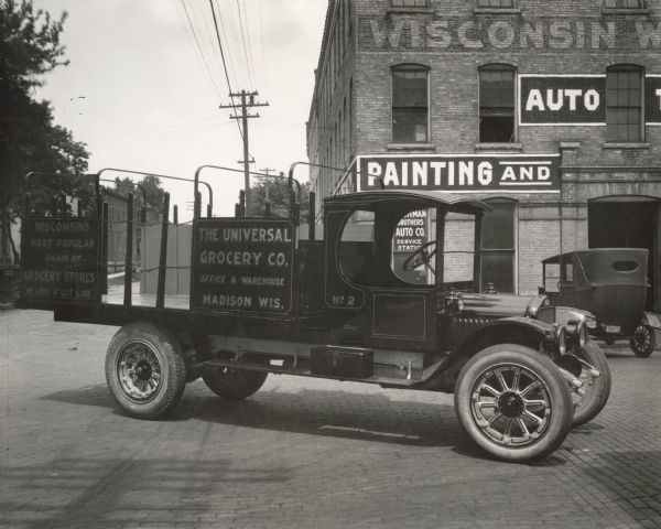 Universal Delivery Grocery Truck built by the Wisconsin Wagon Company.  The photograph was taken in 1921, about the time the company relocated its operations from Sauk City to Madison.  The "We Live and Let Live" sign on the back of the truck is a reference to the fierce competition then current between grocery chains, of which Universal was one, and the independent grocery stores.
