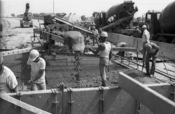 As part of a construction job on one of Wisconsin's interstate highways, concrete travels down a series of chutes from the cement mixer to the pour site.