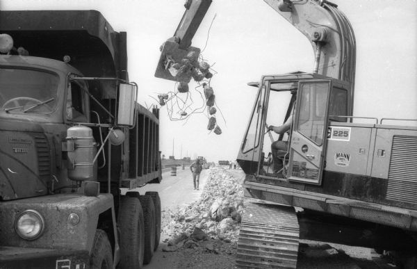 As part of resurfacing work on the Interstate pieces of concrete and rebar are loaded into an International dump truck.