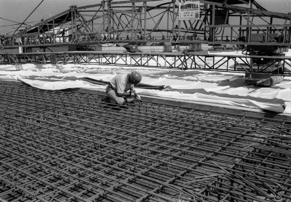 Close-up of rebar work on the Tri-County Fox River Bridge at Appleton, with cement finishing equipment.