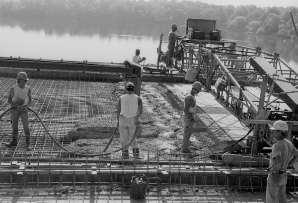 Employees of Lunda Concrete pour the last section of the Tri-County Fox River Bridge deck.