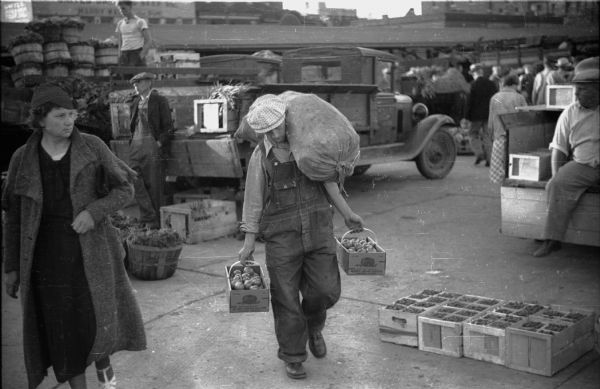 Milwaukee Farmer's Market during the late 1930s. A customer carries produce purchased at the market.